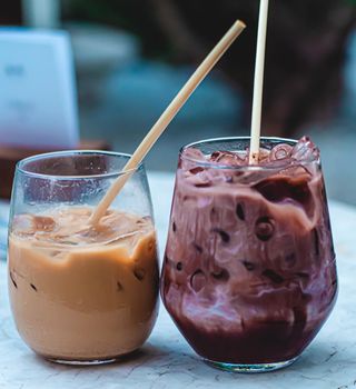 Iced coffee and chocolate in glass. beverage served chilled in nature farm cafe