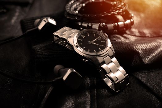 closeup luxury automatic wristwatch for men with black dial and stainless steel bracelet.