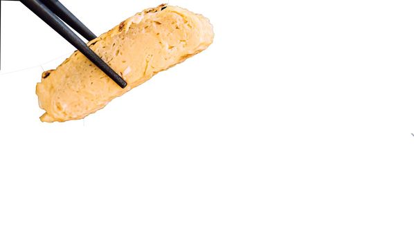 chopstick pick Tamagoyaki or Japanese omelet with path isolate on white background.