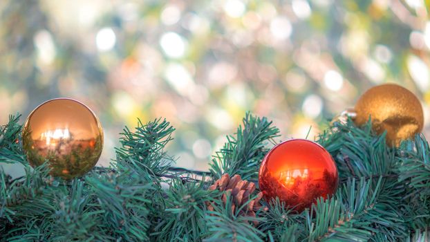 Christmas ornaments gold ball and red ball with blurred bokeh light. Culture religion happy decoration event in winter season.