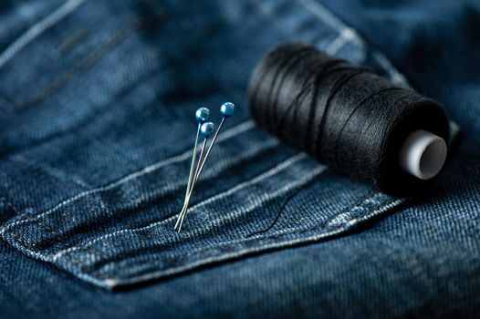 indigo denim fabric with sewing equipments, garment industrial concept.