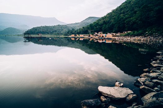 Rafting house on lake .beautiful landscape with foggy over mountains on background in Kanchanaburi Thailand