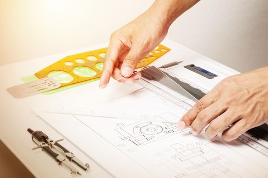 closeup technician's hand while using the industrial drawing tools, industrail drawing concept.