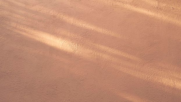 Abstract background from stucco concrete wall with sunlight, light and shadow