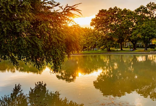 lake at Sunset Chatuchak Public Park, Bangkok, Thailand. Place for people to exercise and relax.