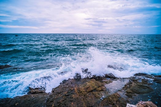 Sea Ocean with Smooth Wave and Rock landscape with blue sky. Nature of Seascape vacation time.