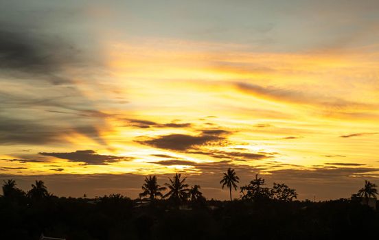 Dramatic clouds at sunset with cityscape silhouette. Abstract season weather vacation time.