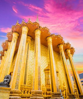 Golden Stupa of Temple of the Emerald Buddha.  Wat Phra Si Rattana Satsadaram.  Wat Phra Kaew. landmark of Bangkok Thailand with pink sky at dusk