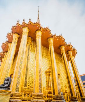 Golden Stupa of Temple of the Emerald Buddha.  Wat Phra Si Rattana Satsadaram.  Wat Phra Kaew. landmark of Bangkok Thailand with pink sky at dusk