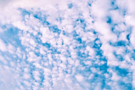 Beautiful white fluffy and cirrocumulus clouds on a blue sky background