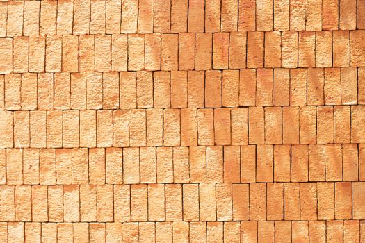 Rectangular orange bricks random pattern wall facade texture material in architecture exterior and interior.