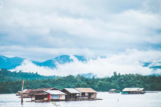 Panorama scenic of rafting house with Foggy Mountain in Autumn on lake