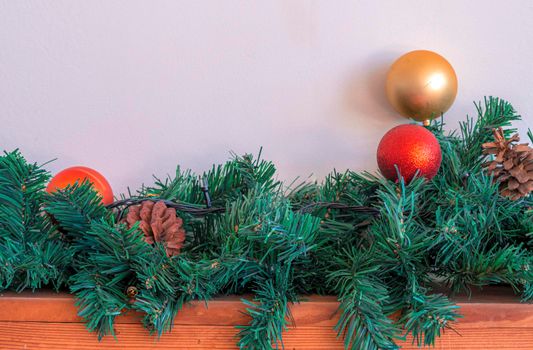 Christmas ornaments gold ball and red ball on wooden and white background.