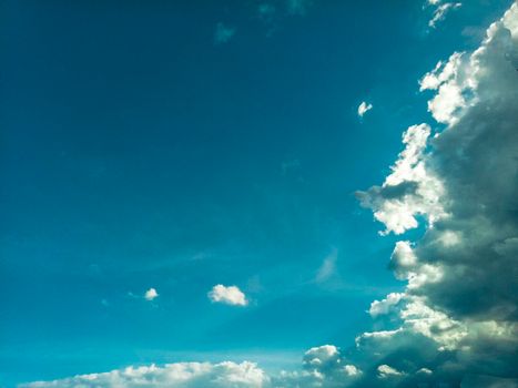 beautiful sky cloudscape .rim light behind dark cloud with blue sky background