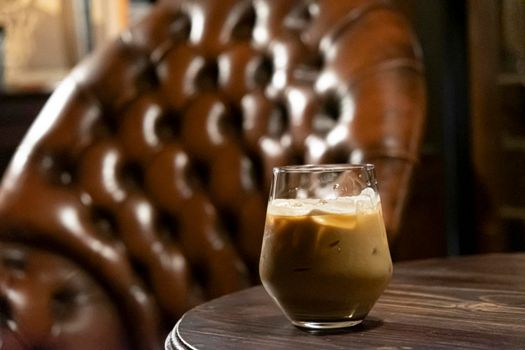 Iced latte coffee glass  on a dark brown tone background