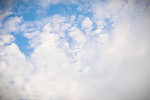 Beautiful white fluffy and cirrocumulus clouds on a blue sky background