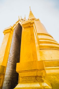Golden Stupa of Temple of the Emerald Buddha.  Wat Phra Si Rattana Satsadaram.  Wat Phra Kaew. landmark of Bangkok Thailand with pink sky at dusk
