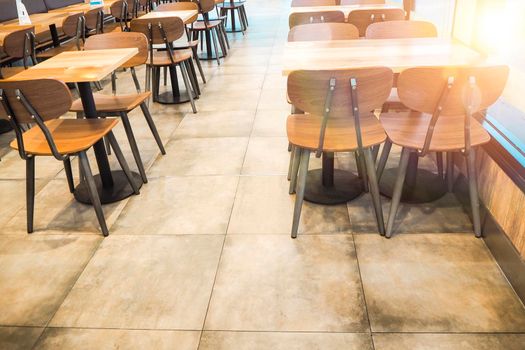 Morning light through rows of  Empty table and chairs in cafe restaurant