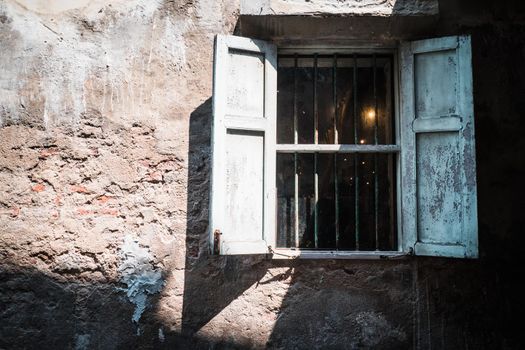 Antique old window on loft industrial grunge exterior wall. Old brick walls and window.