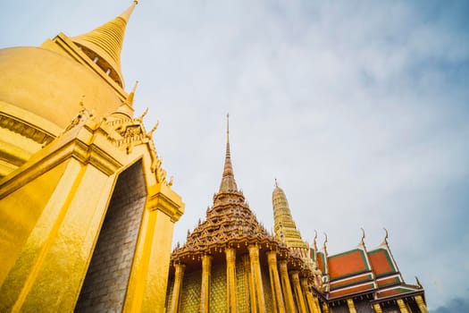 Golden Stupa of Temple of the Emerald Buddha.  Wat Phra Si Rattana Satsadaram.  Wat Phra Kaew. landmark of Bangkok Thailand with pink sky at dusk