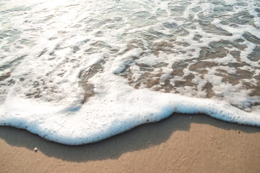 Close Up Wave Sand Beach Sea Foam.  Closeup of sea wave with foam on beach sand. Vacation Summer background