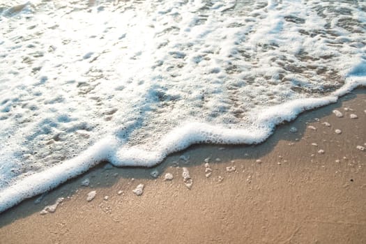 Close Up Wave Sand Beach Sea Foam.  Closeup of sea wave with foam on beach sand. Vacation Summer background