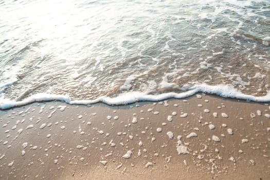 Close Up Wave Sand Beach Sea Foam.  Closeup of sea wave with foam on beach sand. Vacation Summer background