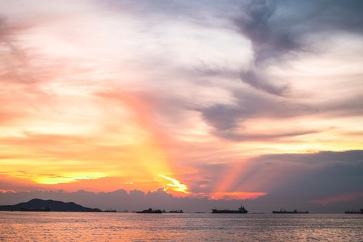 Panorama of Dramatic  orange sky evening beauty and Clouds at sunset , dawn, the rays of the sun break through the clouds over the sea ocean
