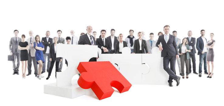 Business teamwork and cooperation concept, business people with giant puzzle pieces . Partnership and collaboration concept, studio isolated on white background