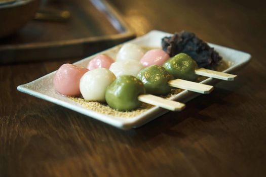Three Color Japanese  Hanami Dango Dumpling sweet dessert on white ceramic plate.