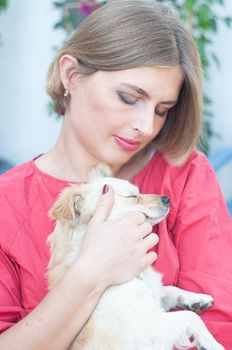 portrait beautiful young blonde smiling and pet dog Chihuahua. High quality photo