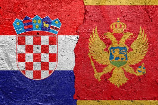 Croatia and Montenegro - Cracked concrete wall painted with a Croatian flag on the left and a Montenegrin flag on the right