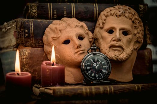 Pocket watch, blur stack of old book, hourglass, vintage binocular and world desk globe on dark background. Journey and Learning Concept, Vintage Style