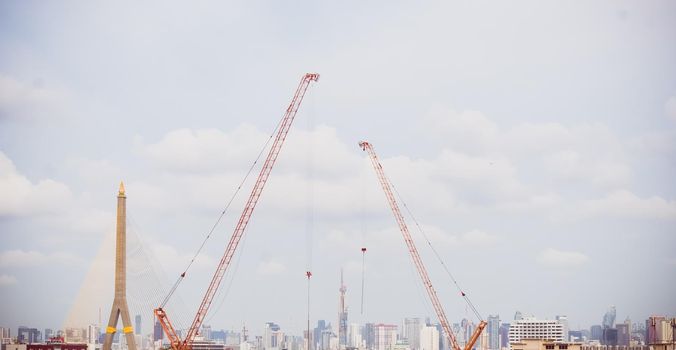 Panorama scenic of Construction Skyline with Blue sky Background and crane on construction Site. Cityscape Urban Facility