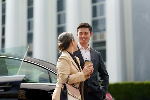 Portrait of Asian Senior Business woman and young business man discussing about Real Estate project