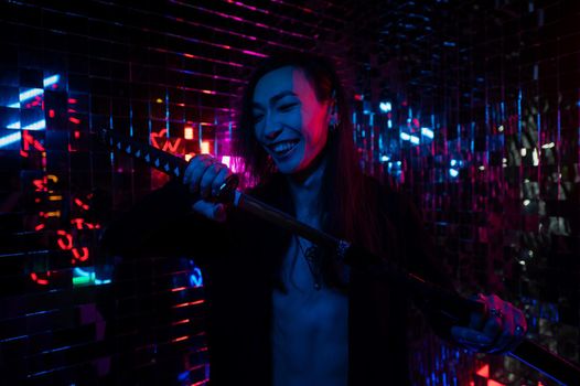 Male transgender neon light studio. Asian with samurai sword