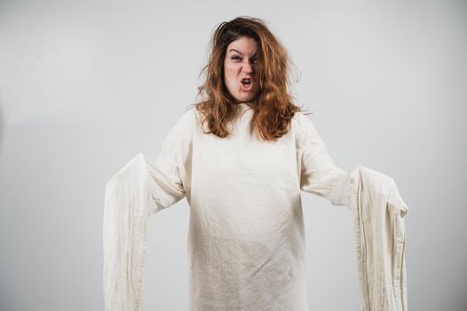 Close-up portrait of insane woman in straitjacket on white background