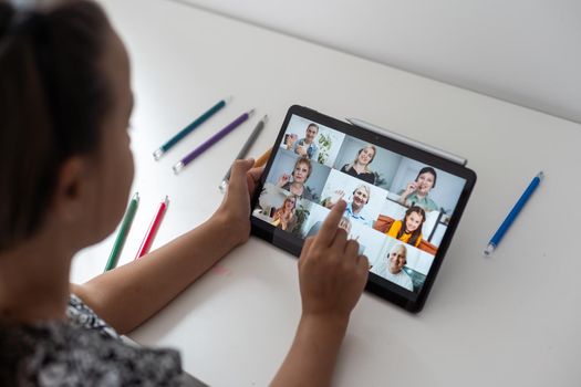 Closeup view of little girl using tablet for conversation video chat at home.