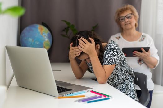 little sad girl and grandmother argue at home.