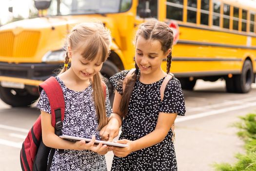 Lucky to meet each other. Cheerful smart schoolgirls. Happy schoolgirls outdoors. Small schoolgirls wear school uniform. Cute schoolgirls looking charming. Ending of school year