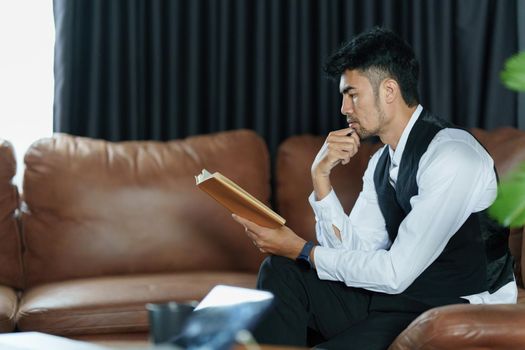 Portrait of Asian Businessman checking schedule and waiting for meet customer