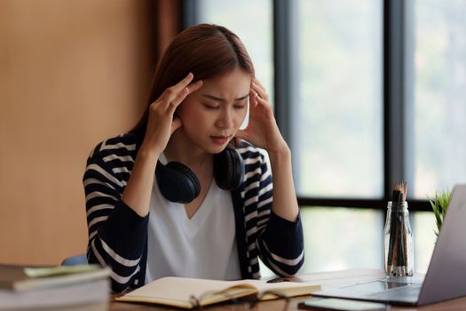 Image of Asian Business woman stressed after end of video conference at home. Expression and Emotional concept