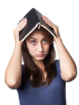 Education. Tired girl holds a notebook on her head on a white background