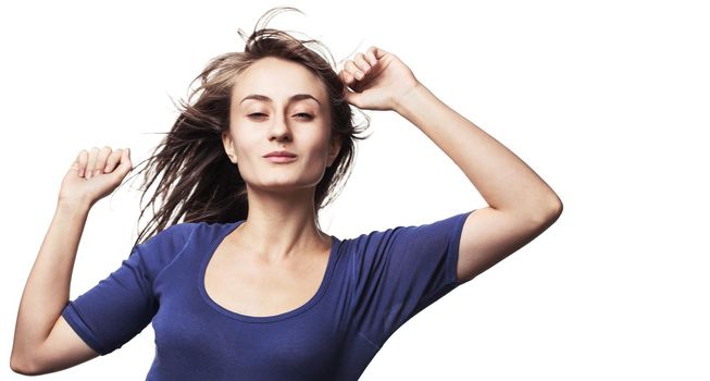 Portrait of a beautiful young woman dancing with hair flying. Isolated on white with copy-space. High-contrast image with intentional color shift