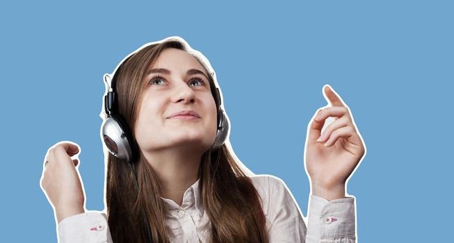 Lifestyle concept. Young happy woman listening to music on headphones.  Magazine style collage with copy space and blue background