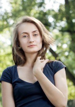 Portrait of a young woman on blured forest background