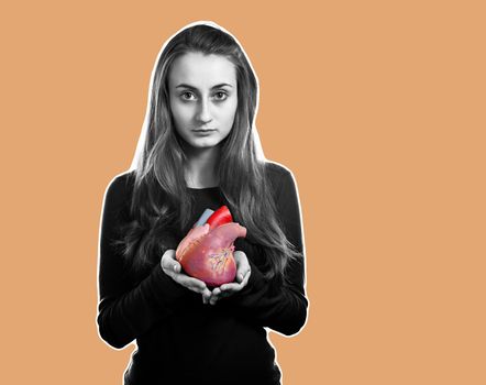 Young woman with a heart in her hand.  Magazine style collage with copy space