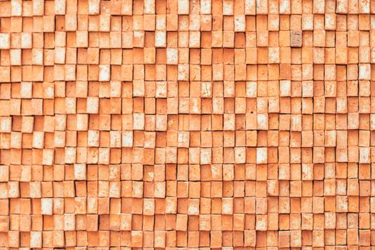 Rectangular orange bricks random pattern wall facade texture material in architecture exterior and interior.