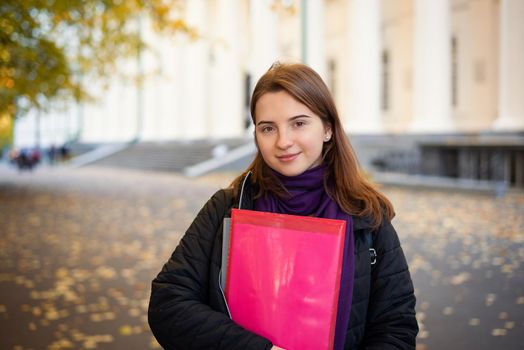 Portrait of a lovely student near conventional university