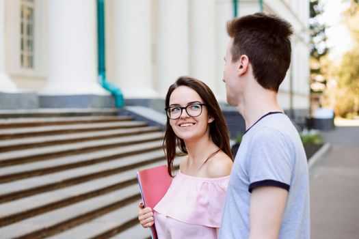 Two students in love attending lectures of a conventional university